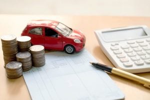 Calculator with Toy Car and Pen, Paper, and Coins