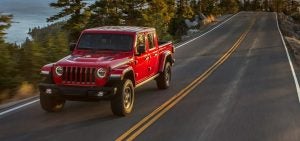 2021 Red Jeep Gladiator Driving Down Highway