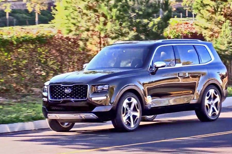 black 2020 kia telluride driving down a street