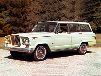 A greenish 1963 Jeep Wagoneer in a driveway
