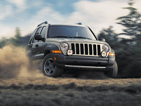 Front view of a 2004 Jeep Wrangler Unlimited driving on dirt trails