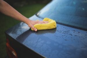 someone washing winter salt off of their car