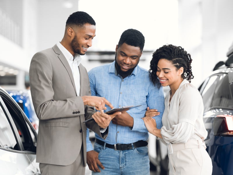 Car,Rent.,Afro,Salesman,Offering,Couple,Automobile,Standing,In,Auto