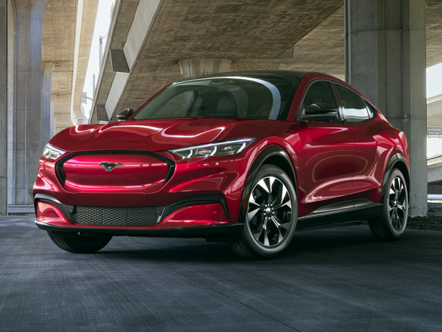 All-New 2024 Rapid Red Metallic Ford Mustang Mach-E parked underneath an overpass in Norwood, MA.