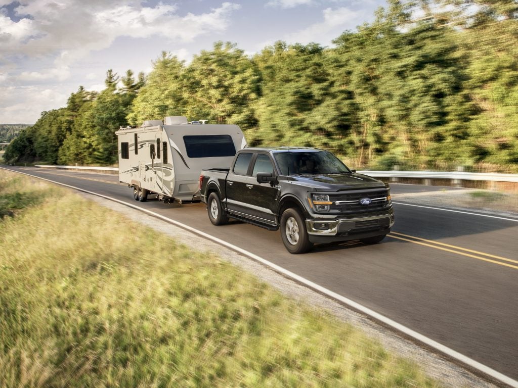 2025 Ford F-150 towing camper on road-trip