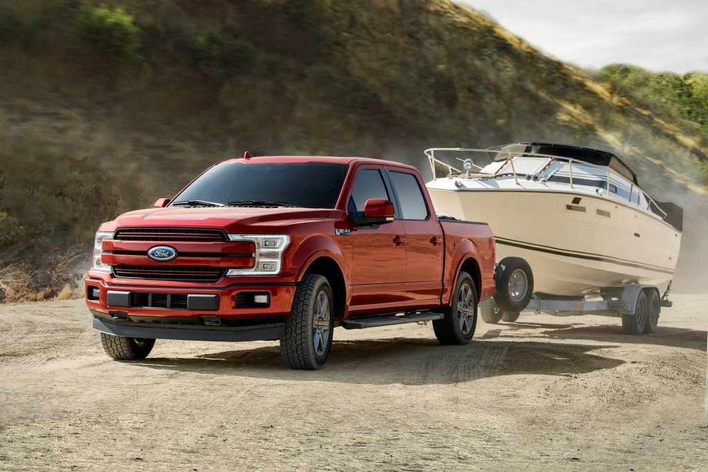 Red truck towing a boat