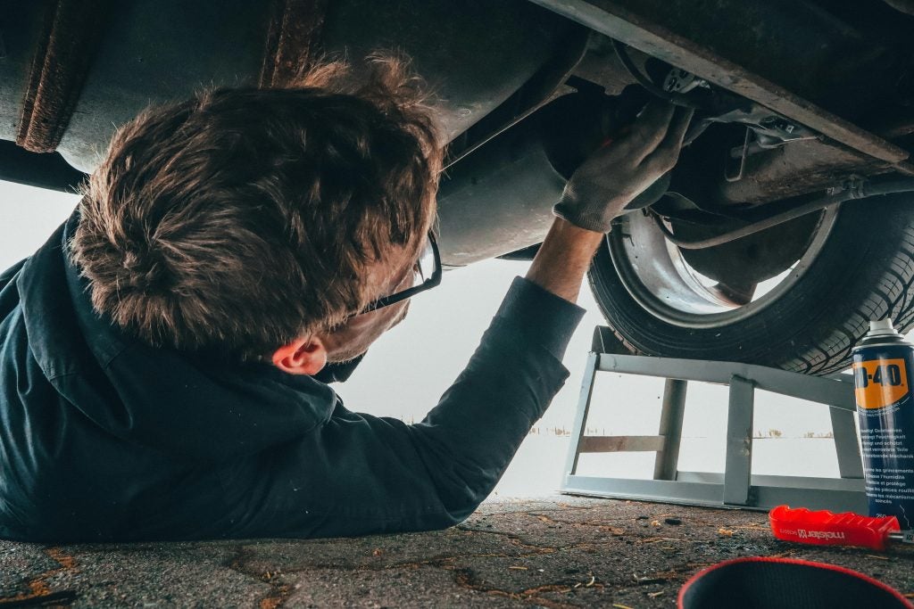 man performing vehicle maintenance