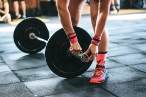 Person Lifting Weights at Gym