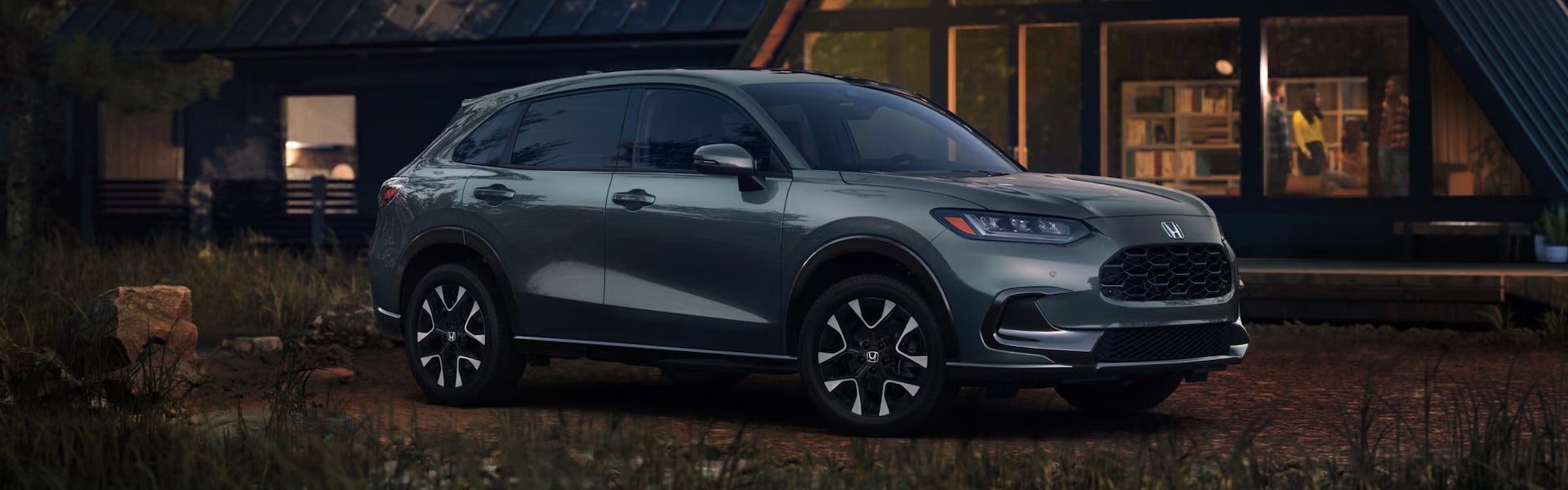 Gray Honda SUV parked near a home