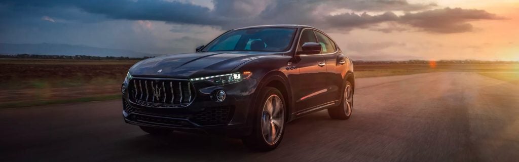 Maserati Levante riding in a road during sunset, showcasing Italian design, powerful performance, and genuinely useful technology into one refined package.