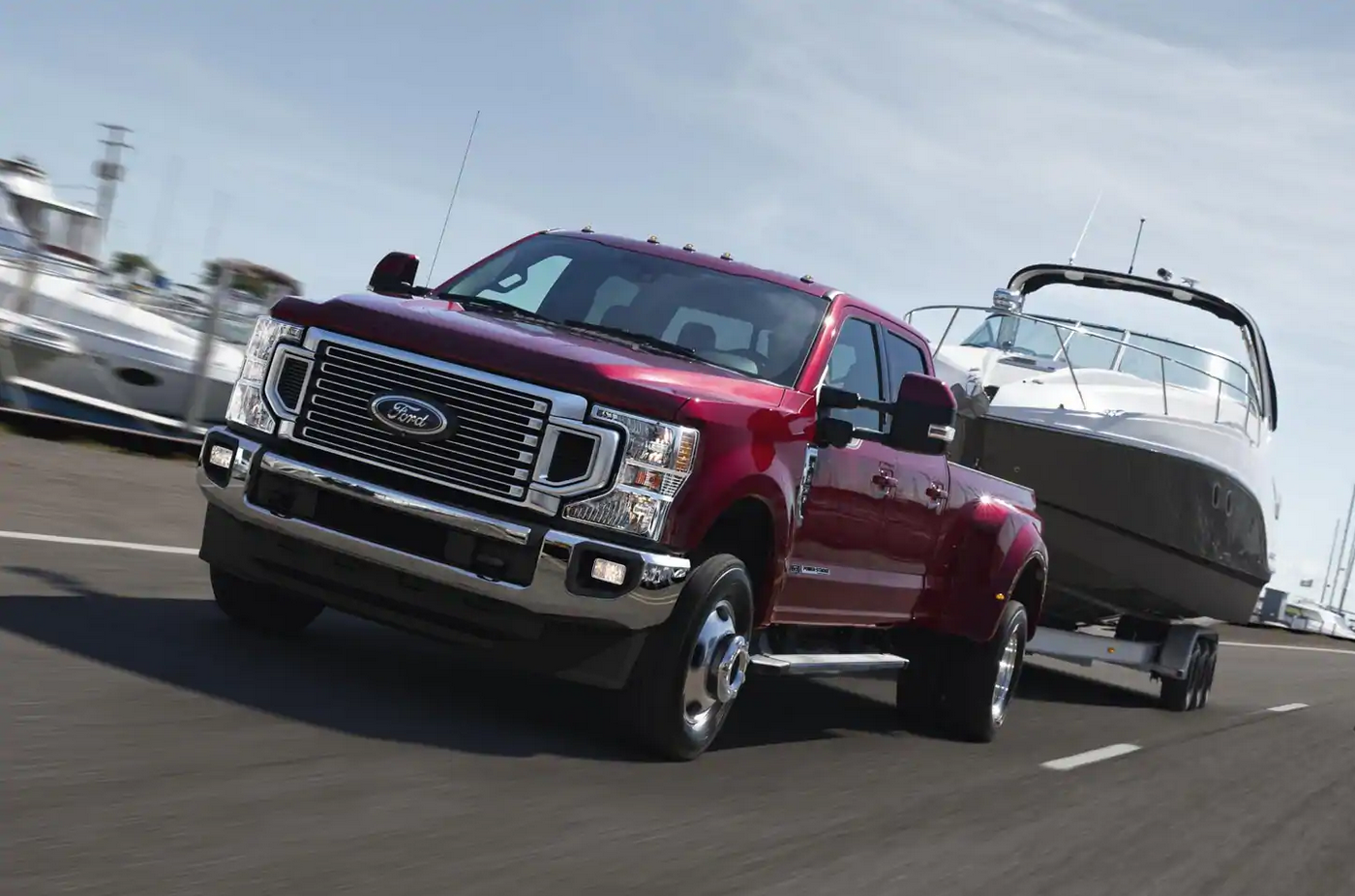 Red 2020 ford f-350 towing a boat