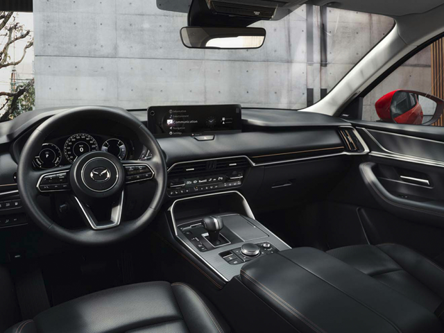 The dashboard and driver's seat of a Mazda vehicle
