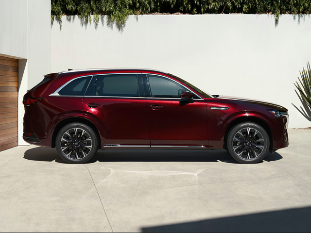 A red Mazda SUV parked near a building