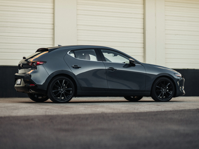 A side view of a Mazda3 Hatchback parked outside