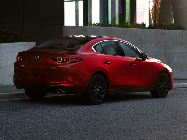 A red Mazda3 on the road