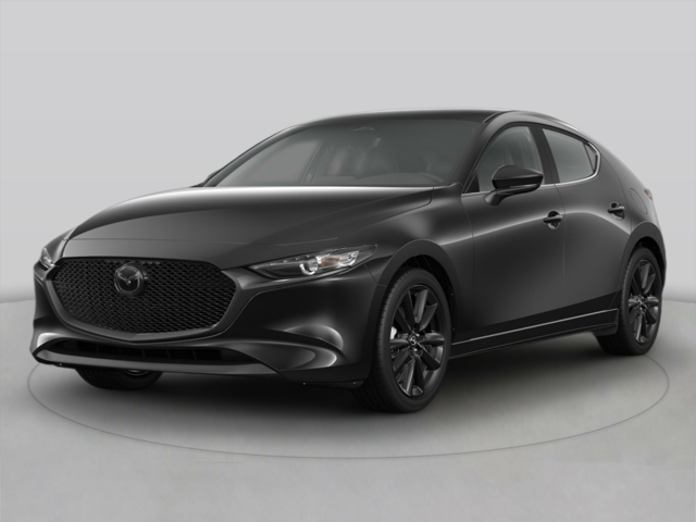 A black Mazda parked inside