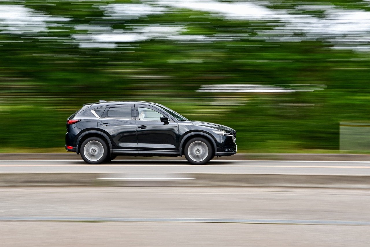 A black car driving on the road