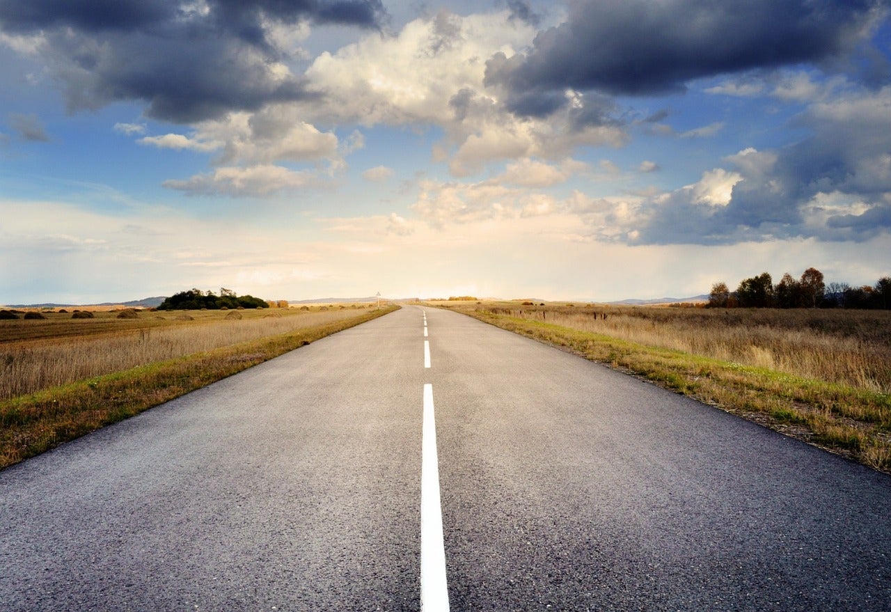 Some clouds over a long road