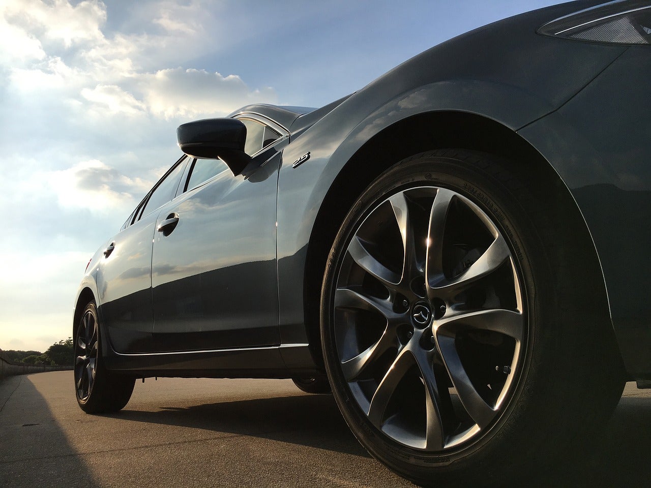 A Mazda sedan focused on the wheels