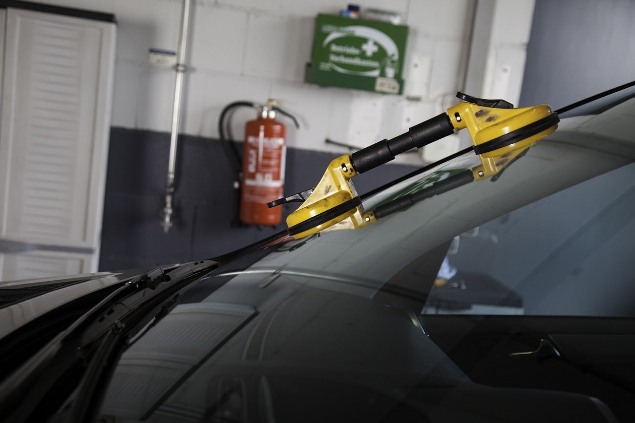 A windshield being fixed in an auto shop