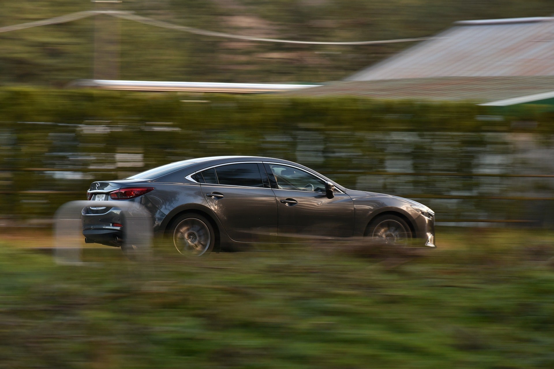 A Mazda sedan driving