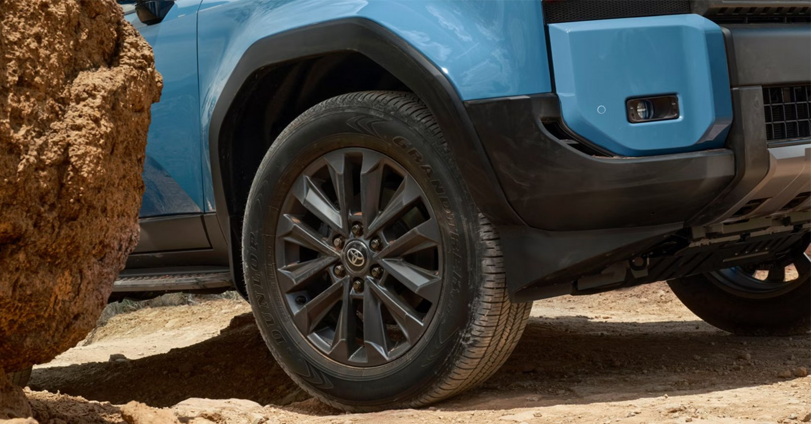 Front view of a Toyota Tundra pickup truck, focusing on its black grille, headlights, and front bumper.