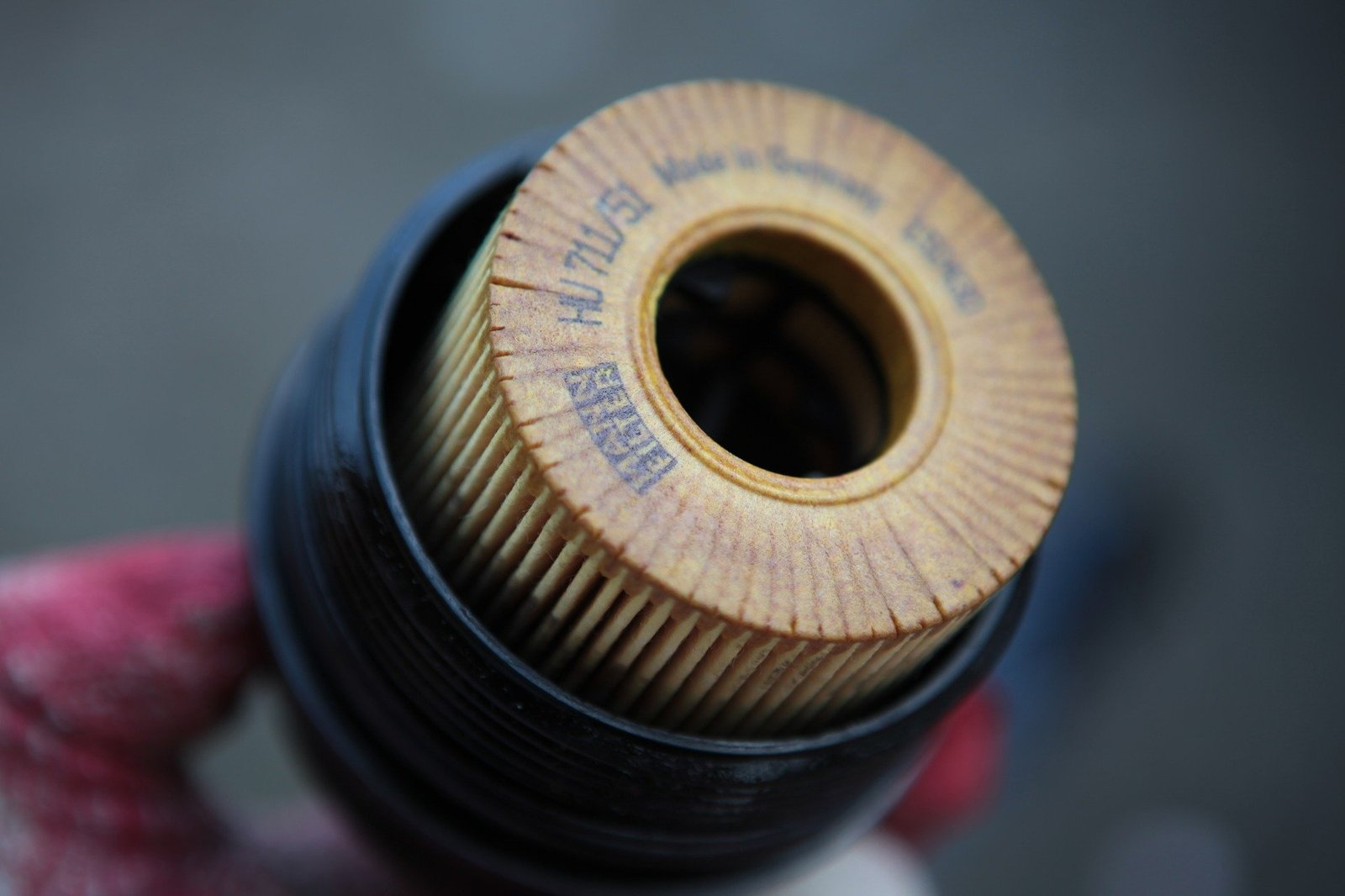 Close-up, monochromatic view of an automobile's air filter and chrome engine details.