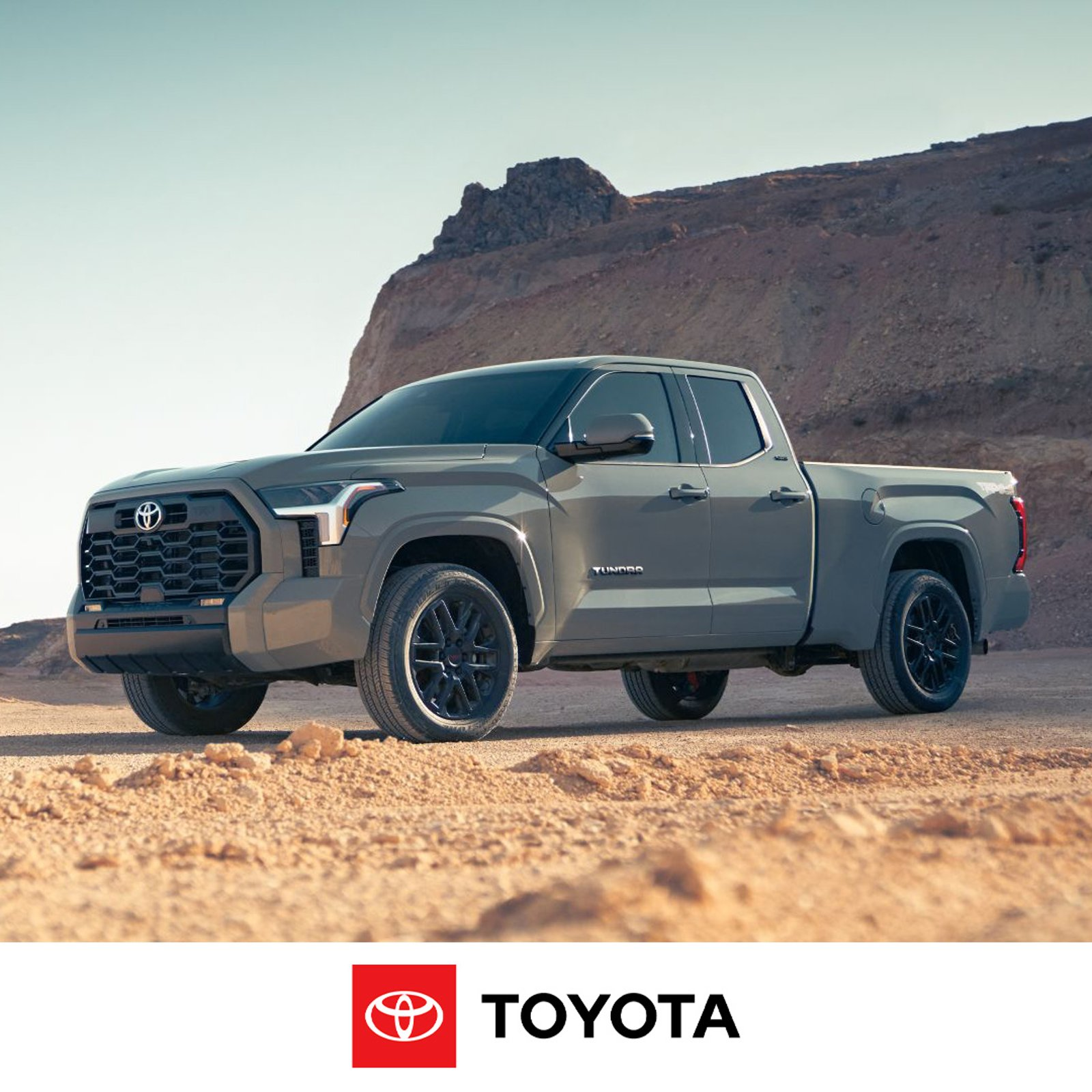 Toyota Tundra trucks, driving on a dirt road.