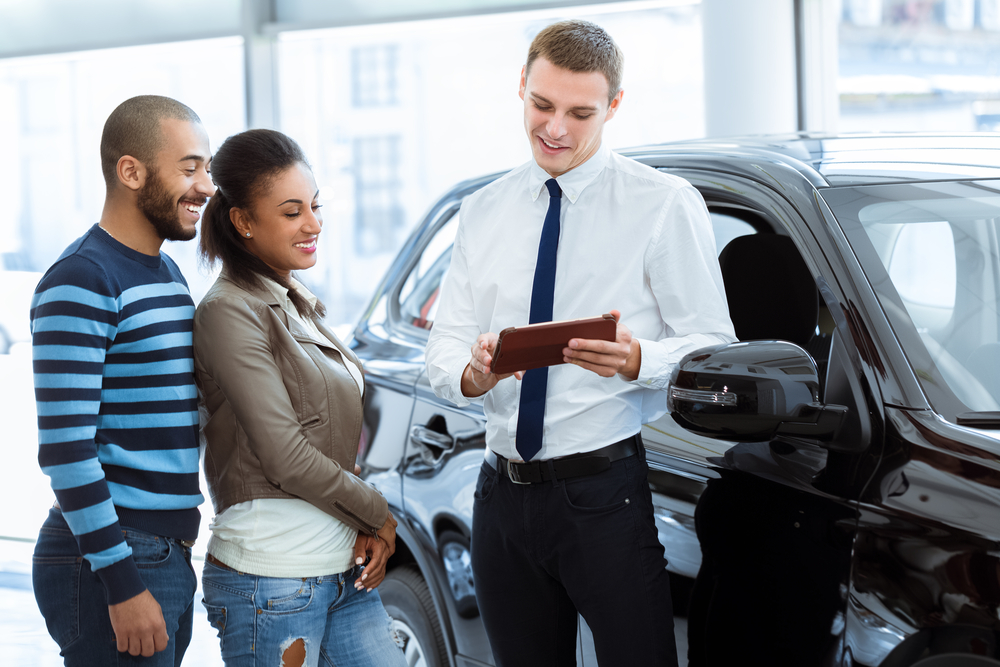 Car Salesman with Car Buyers