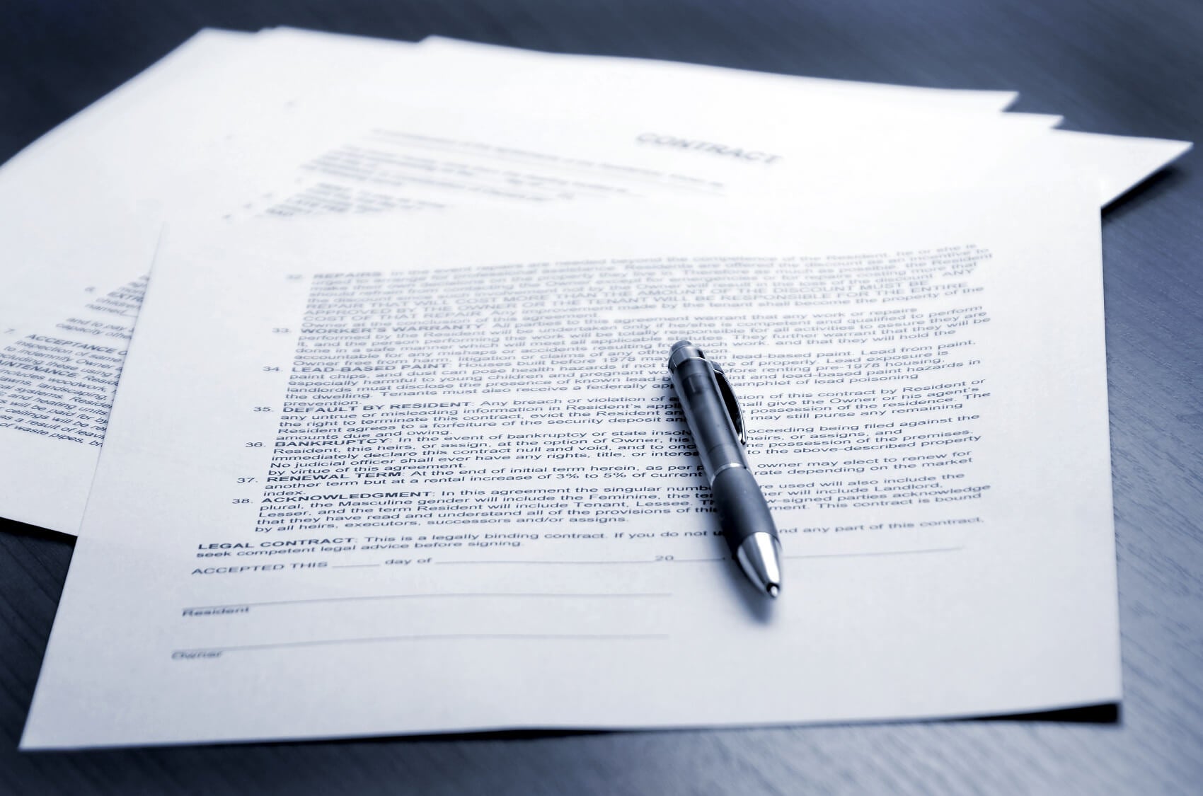 Financial papers representing lease agreement placed on a table with pen