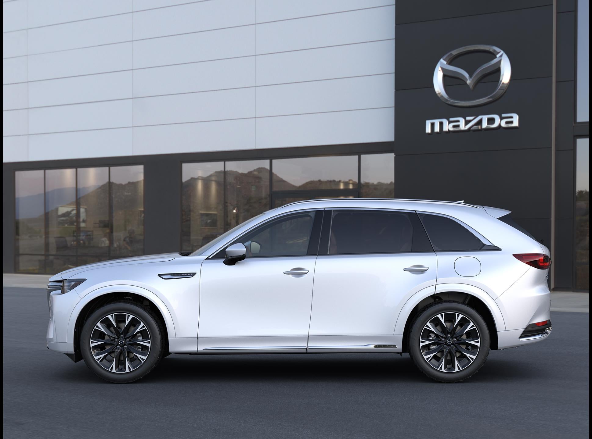 2025 White Mazda CX-90 in front of a Mazda Dealership