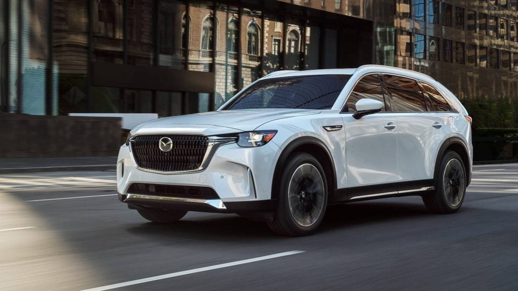 2026 Mazda CX-90 white SUV driving on city street