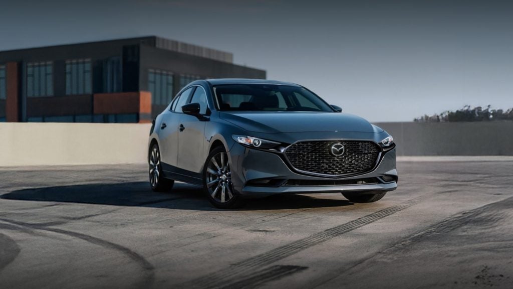 2026 Mazda3 Sedan parked on a rooftop, highlighting its sleek design and modern styling.