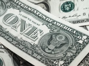 A pile of one dollar bills, U.S. Currency.