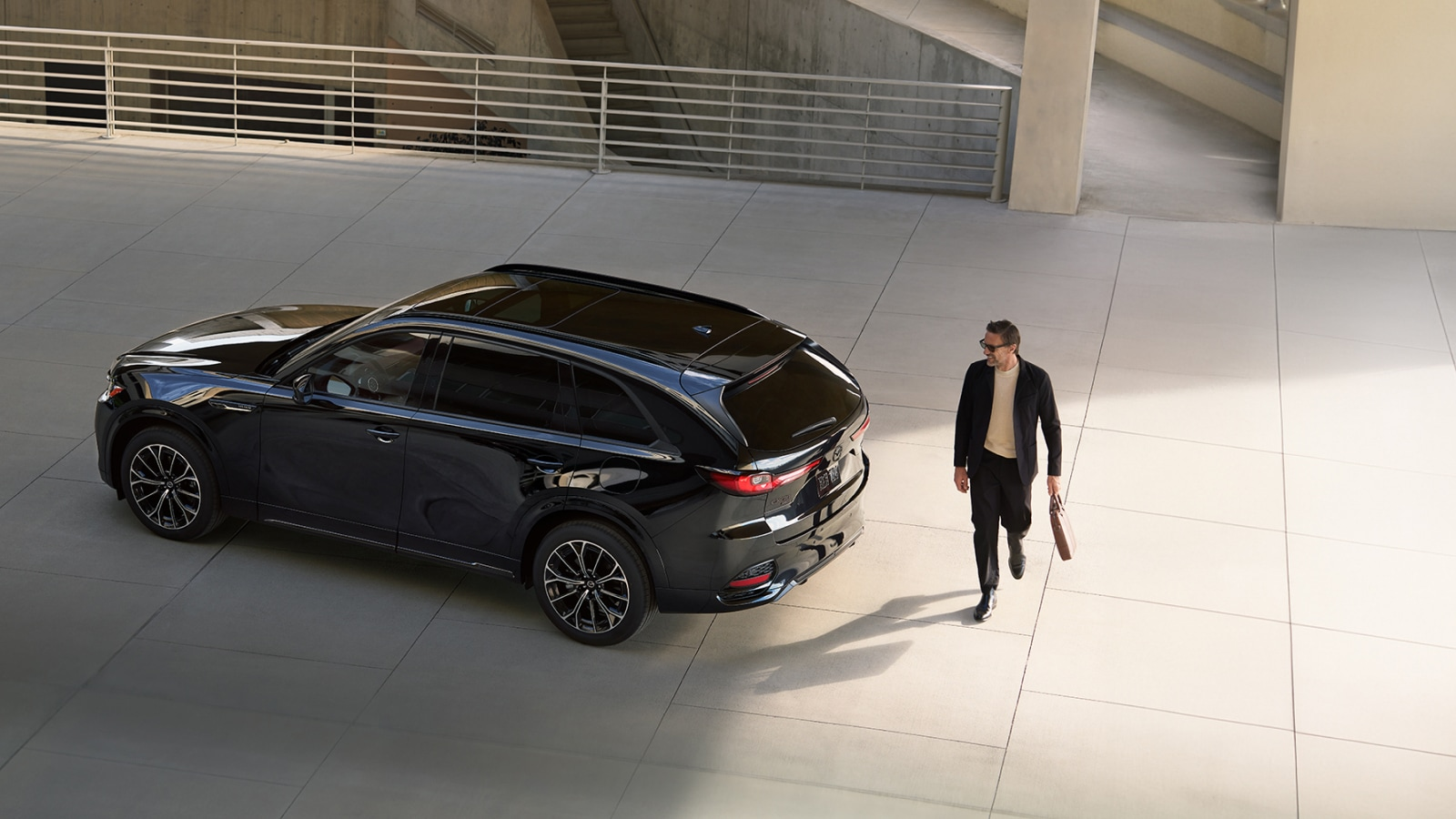 Person walking near a new Mazda model