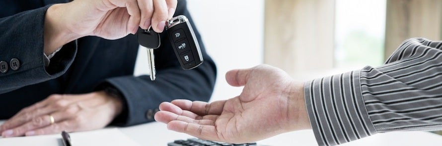 Jeep Finance team handing new customer over keys to car Taylor Mi
