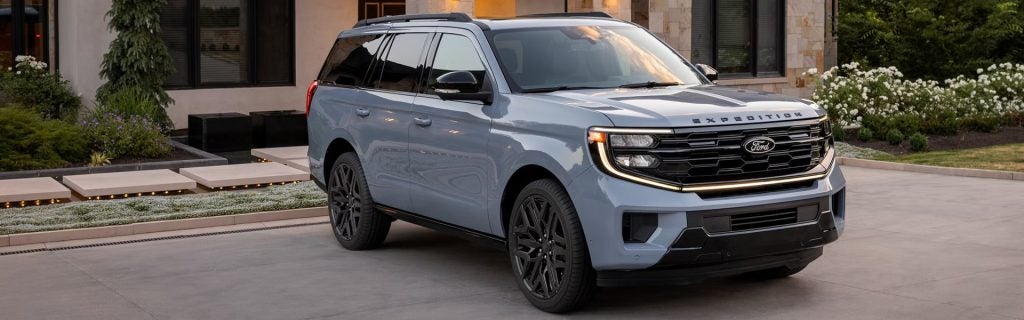 A modern SUV parked in a residential driveway, showcasing style and everyday practicality.