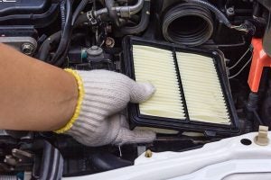 A hand changing the air filter - basic car maintenance 