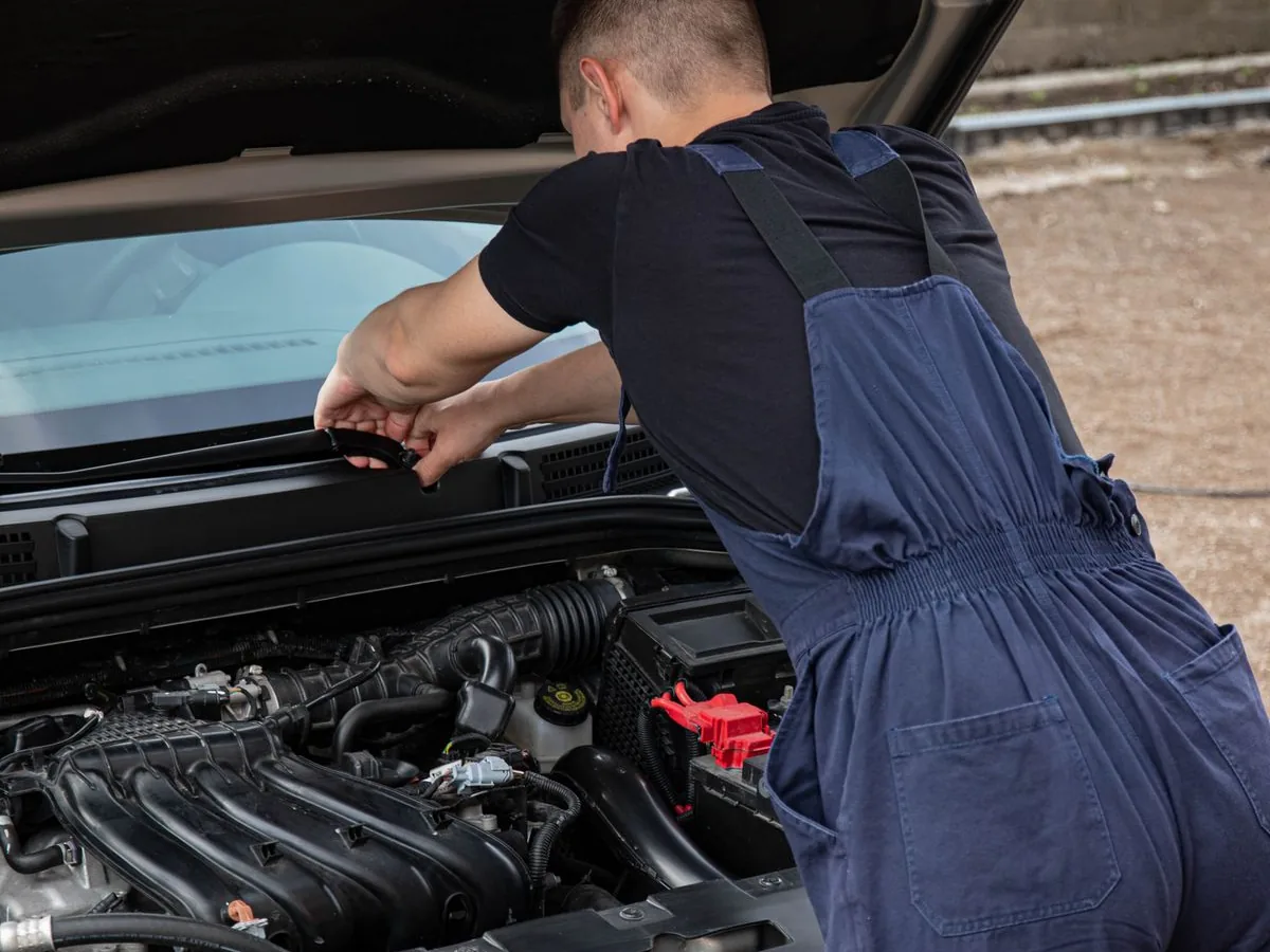 Technician servicing a customer's vehicle on site with Atchinson Ford mobile service