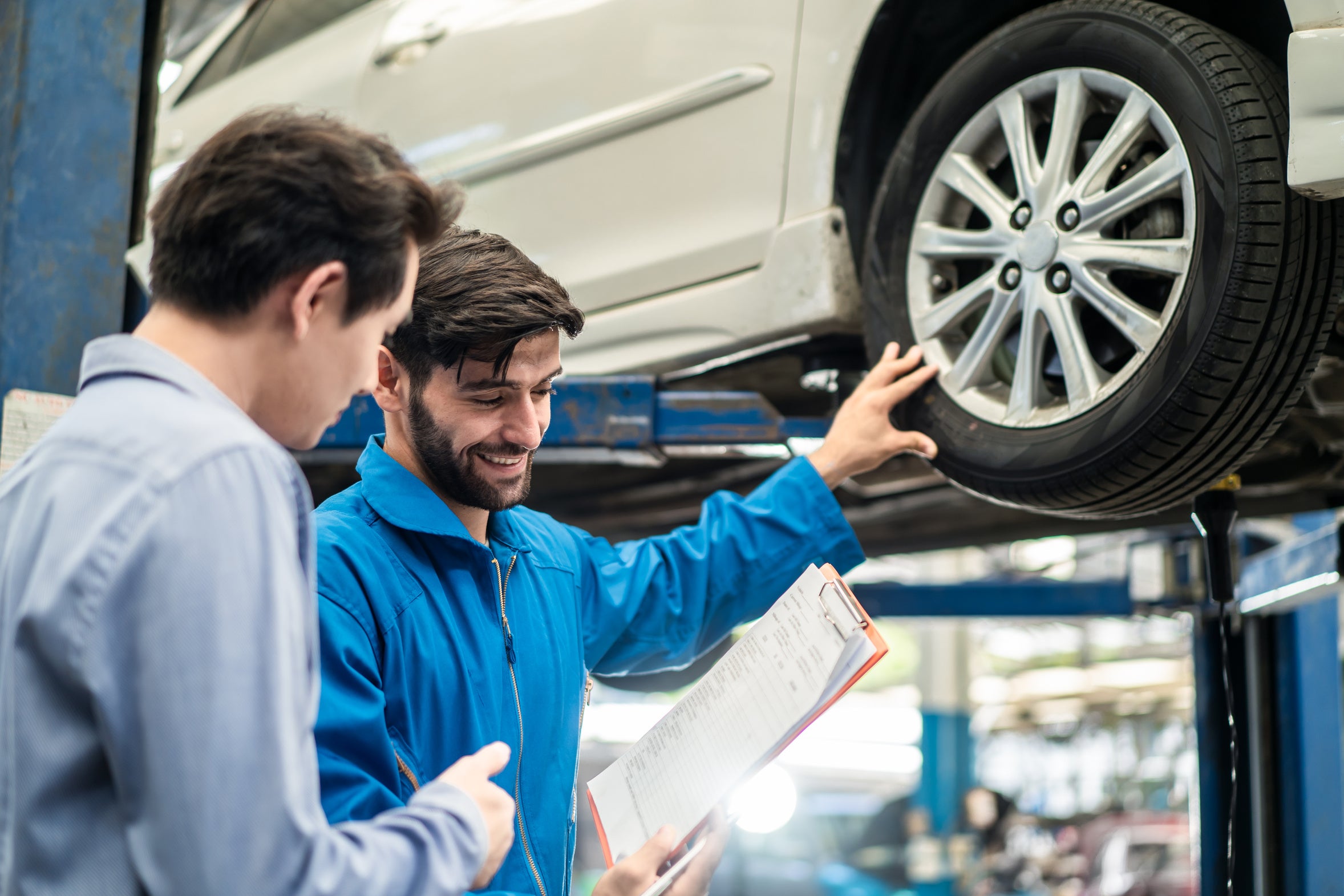 A Ford service advisor reviewing warranty coverage with a customer