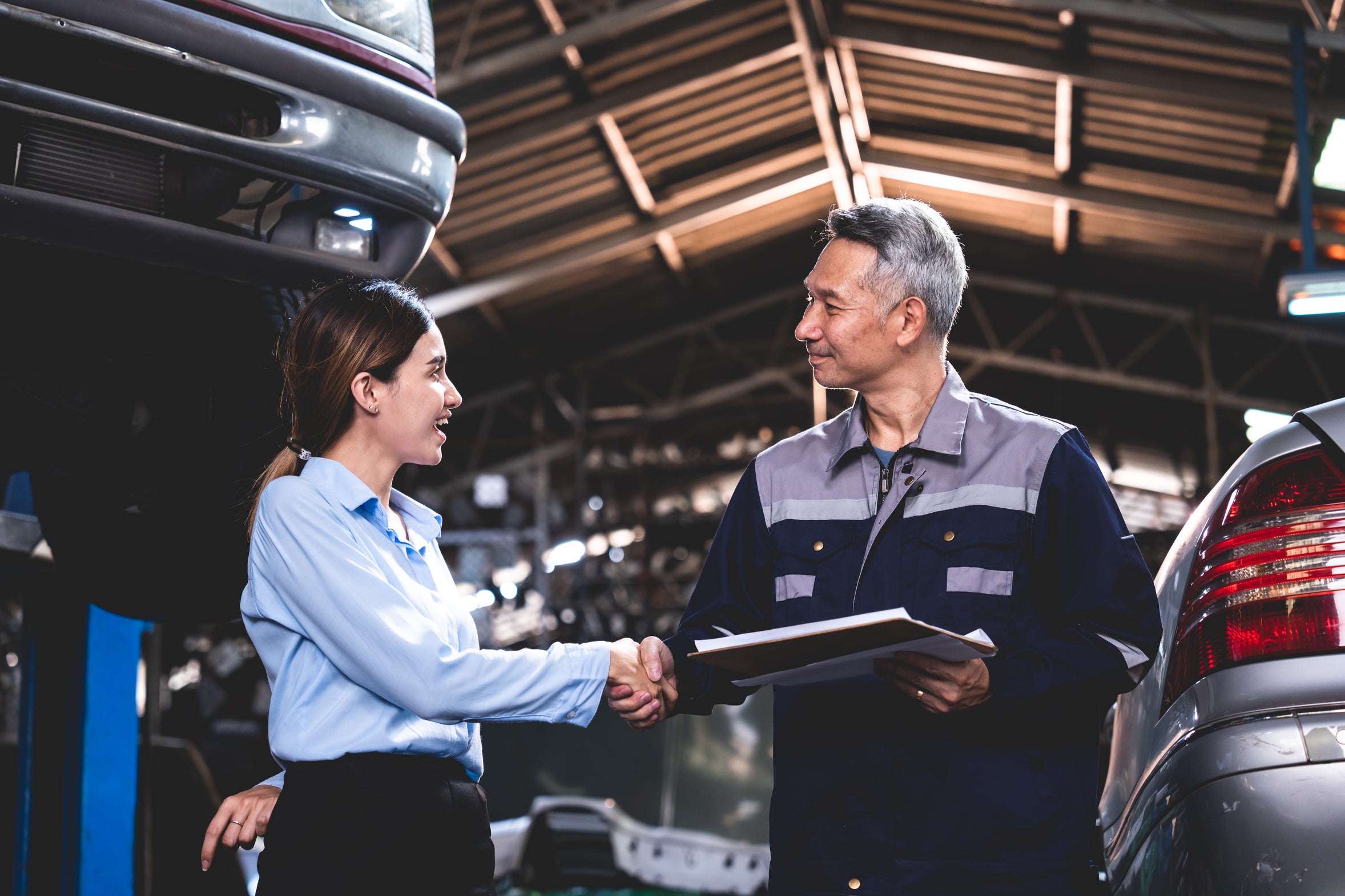 A service advisor reviewing a vehicle repair estimate with a customer