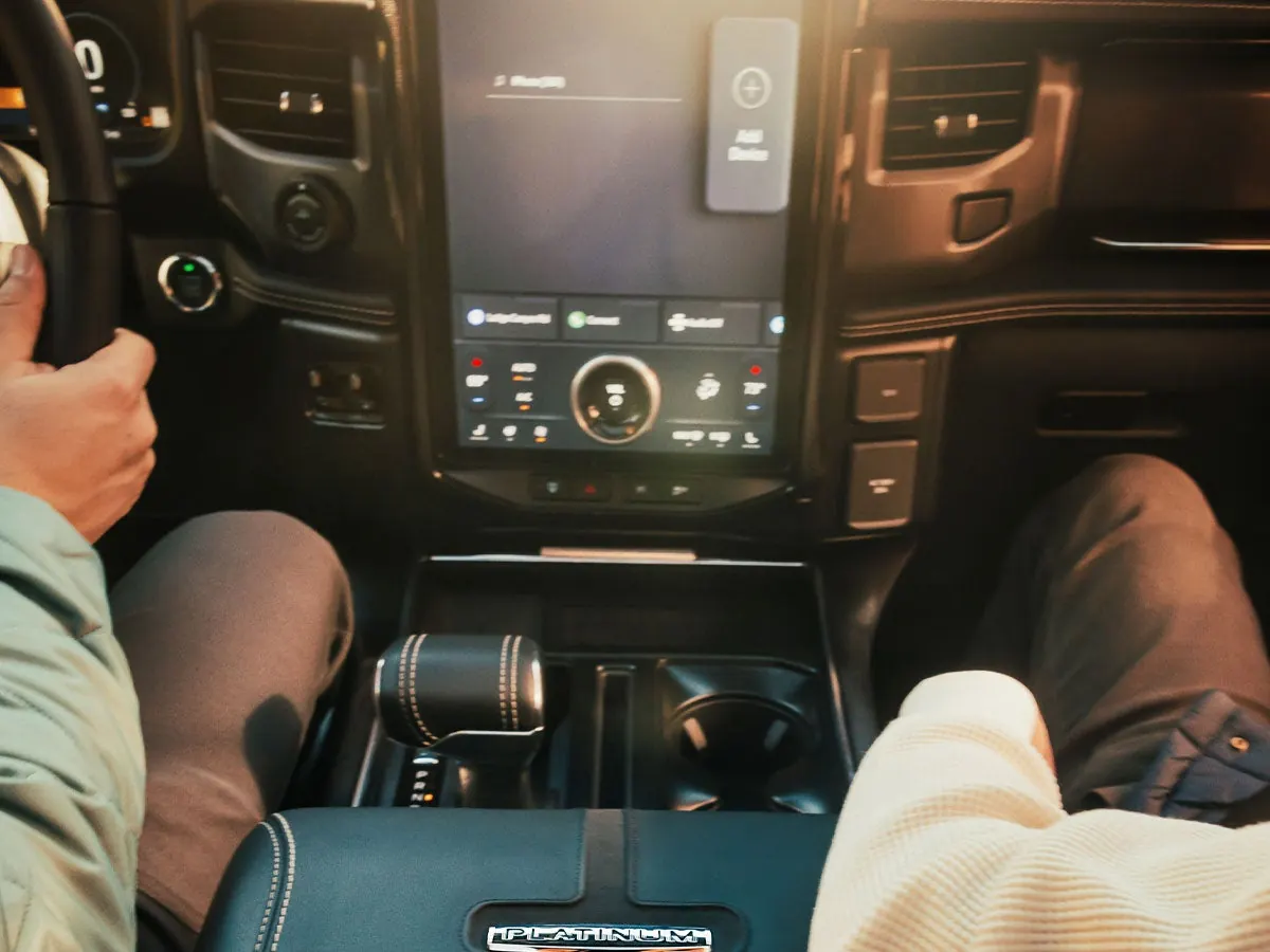 F-150 Lightning cabin with large center touchscreen and hands on the wheel