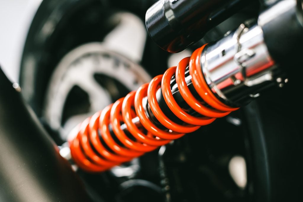 Mechanical detail of a suspension system showing a coiled spring.