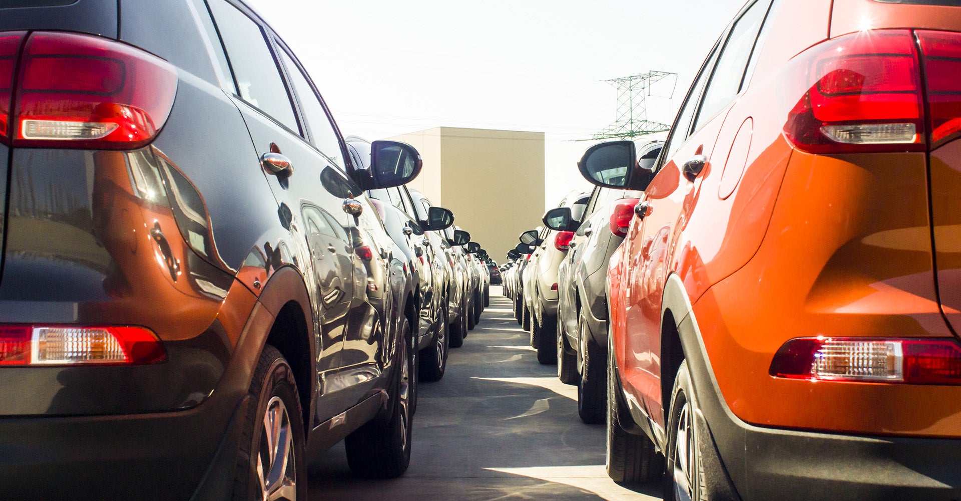A dealership lot where customers can choose a new vs pre-owned vehicle - Are Used Cars Reliable? Pros and Cons of Buying New vs. Pre-Owned 