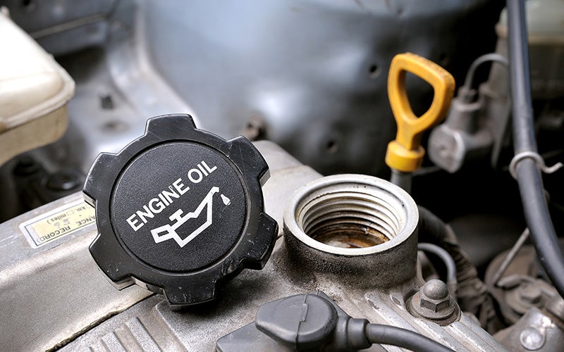 An engine oil cap removed and displayed prior to an oil change