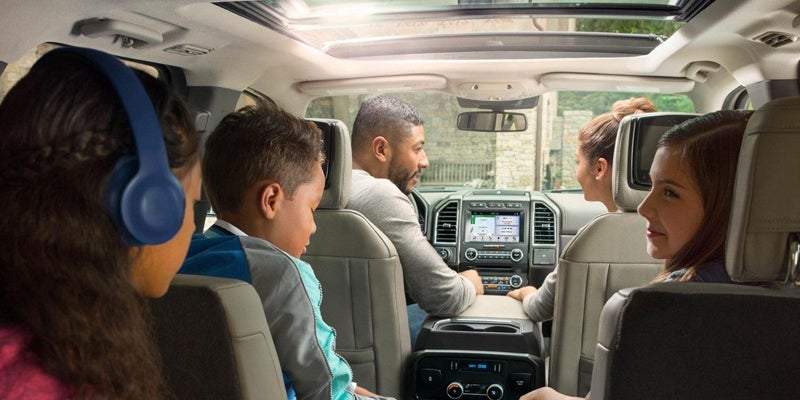 A family of five riding in a vehicle they purchased on a budget - Used Fords: Perfect for Budget-Conscious Families