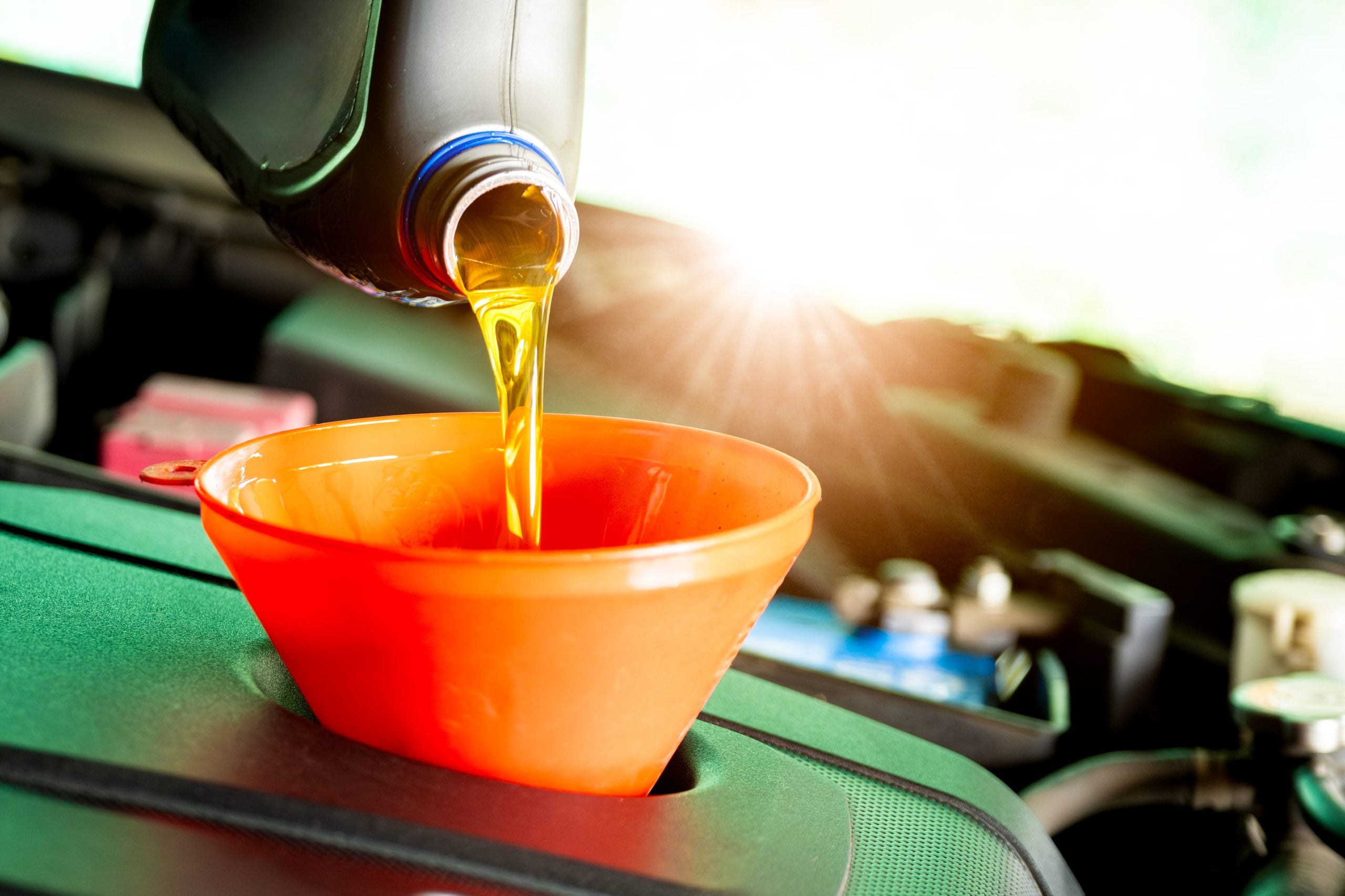 Refueling and pouring oil quality into the engine motor car Transmission and Maintenance Gear.Energy fuel concept