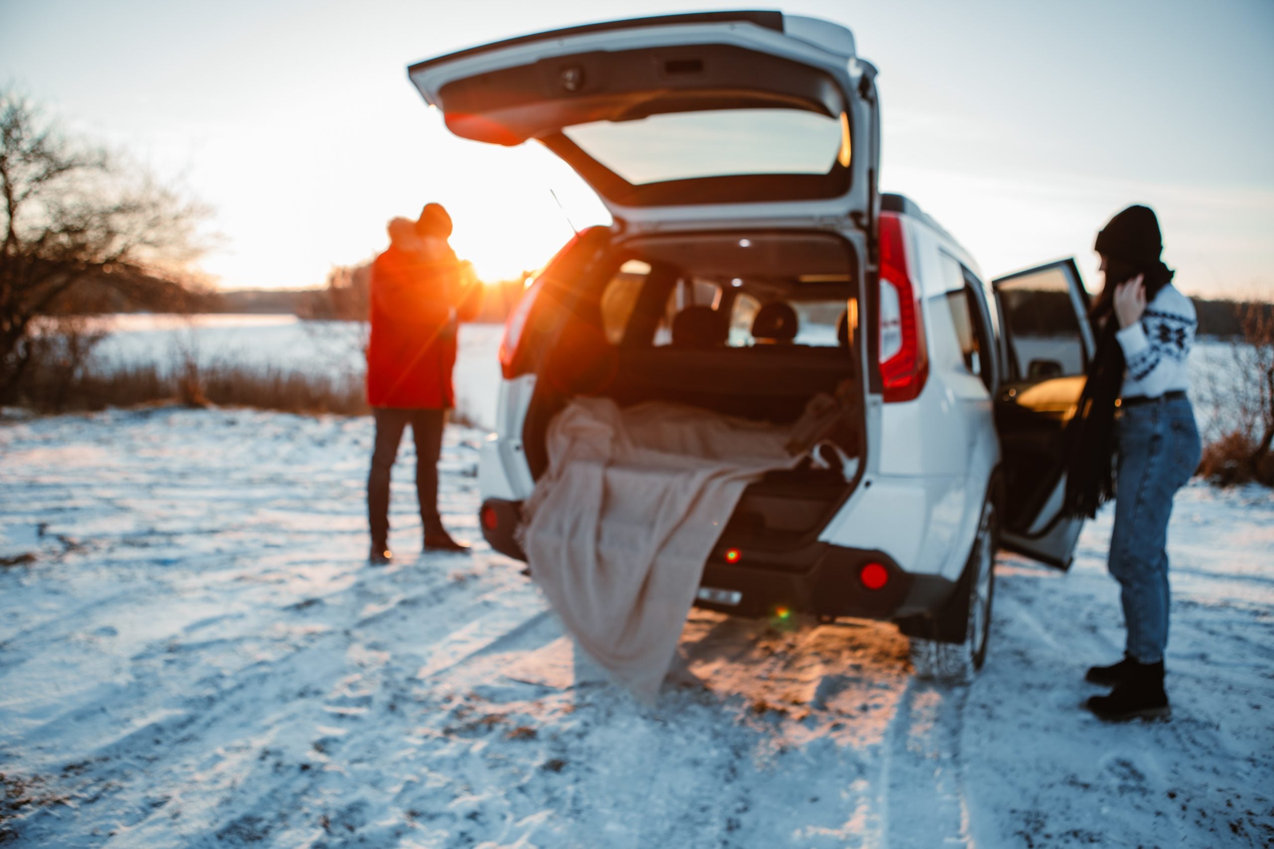 couple near car at winter sunset