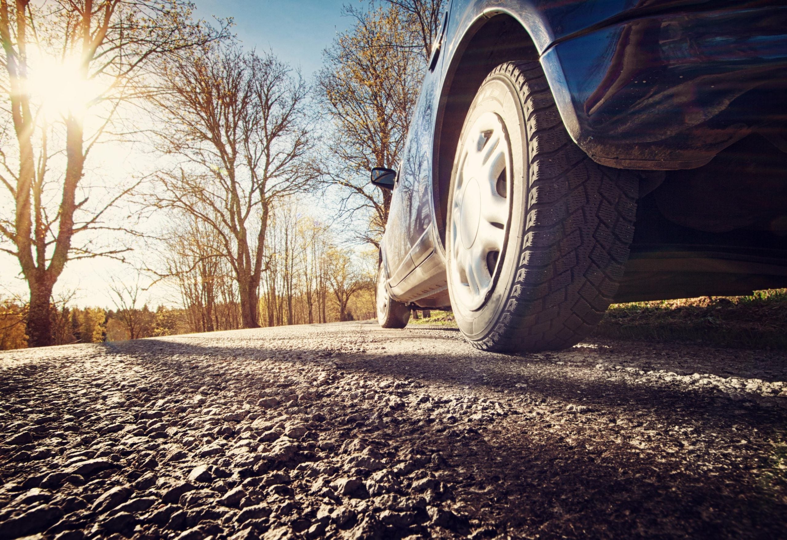 Car on asphalt road in spring morning