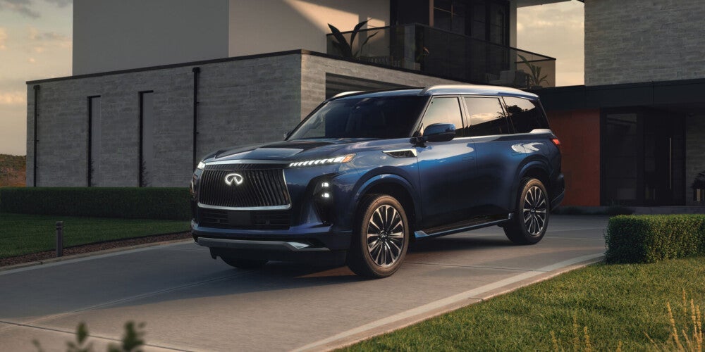 Navy blue 2025 INFINITI QX80 parked in driveway